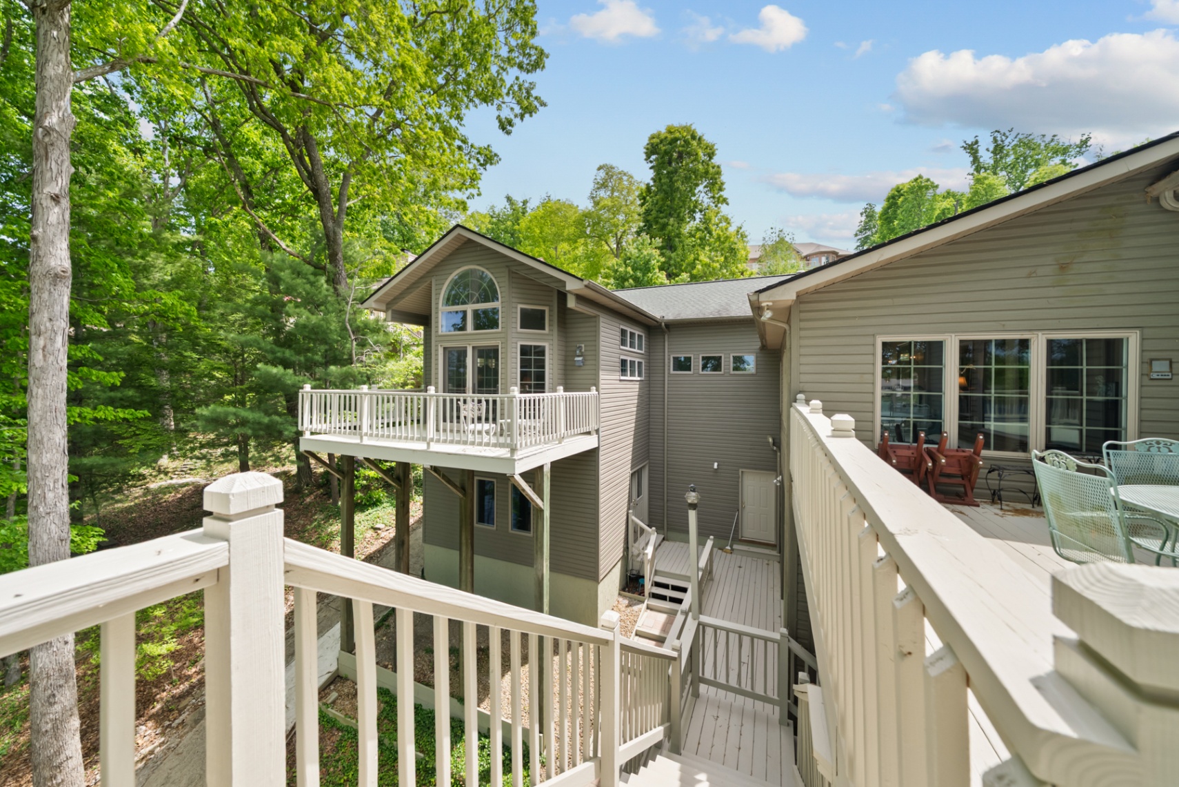 Upper and lower decks overlooking the wooded lakefront