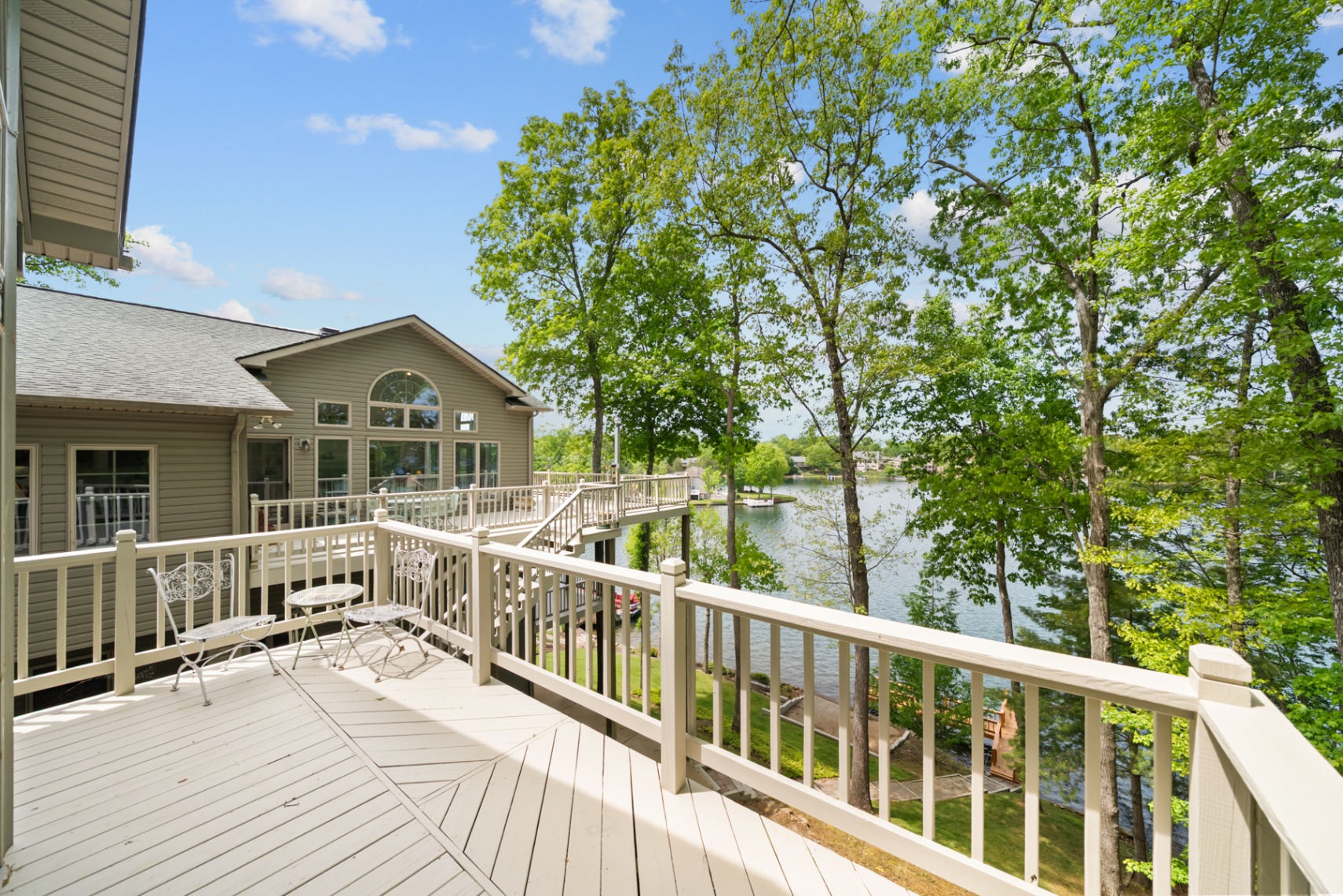 Expansive upper deck with outdoor seating and lake views