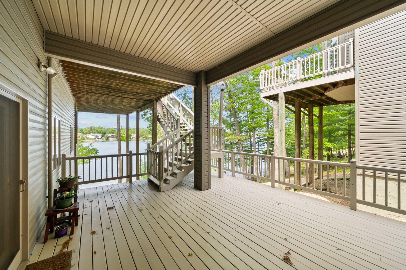 Lower-level covered outdoor living area with connecting stairs