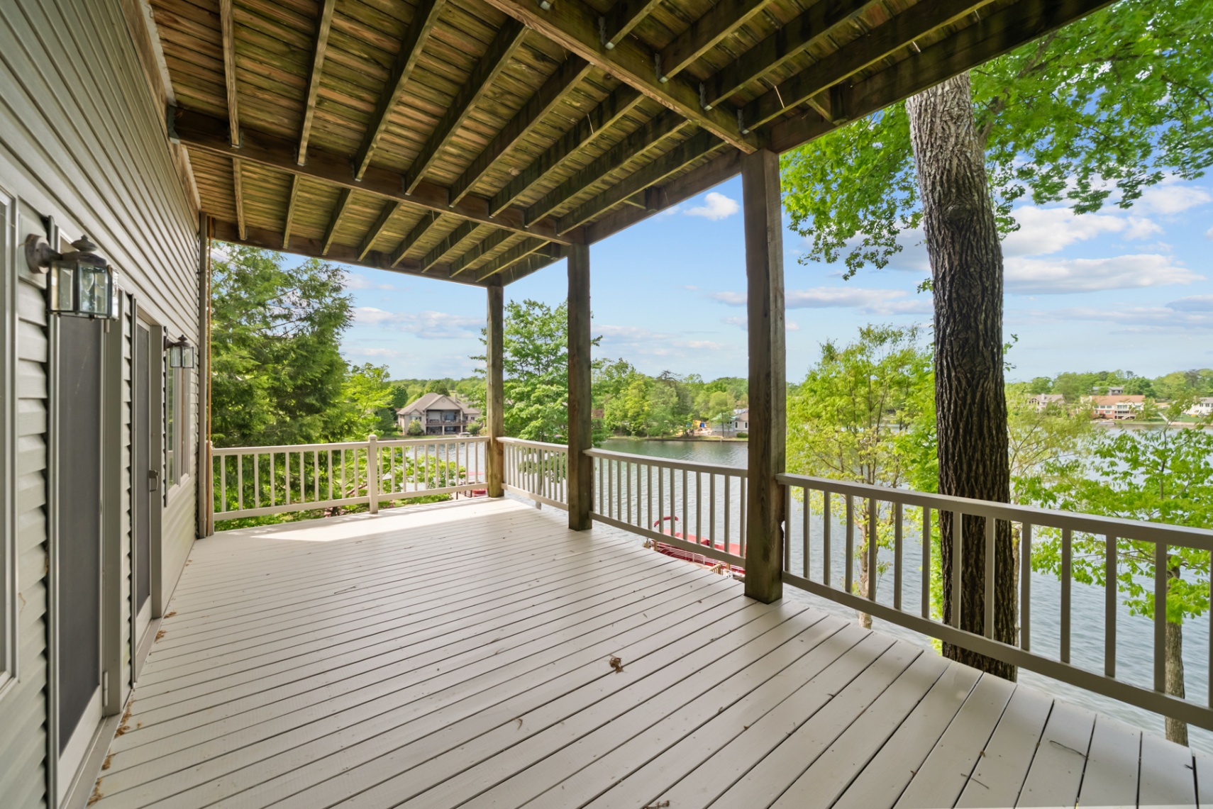 Spacious covered lakefront deck beneath the main level