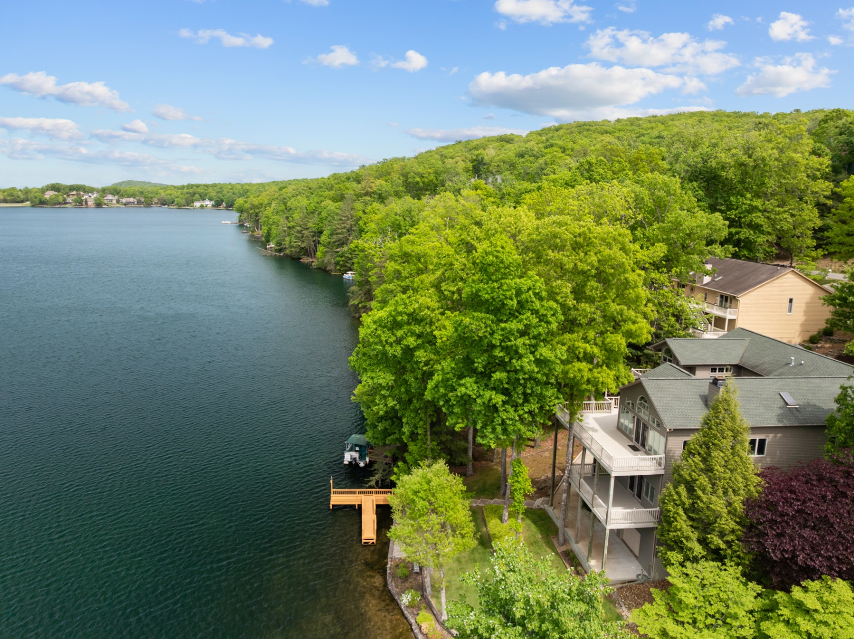 Side view of the home along the shoreline with private dock