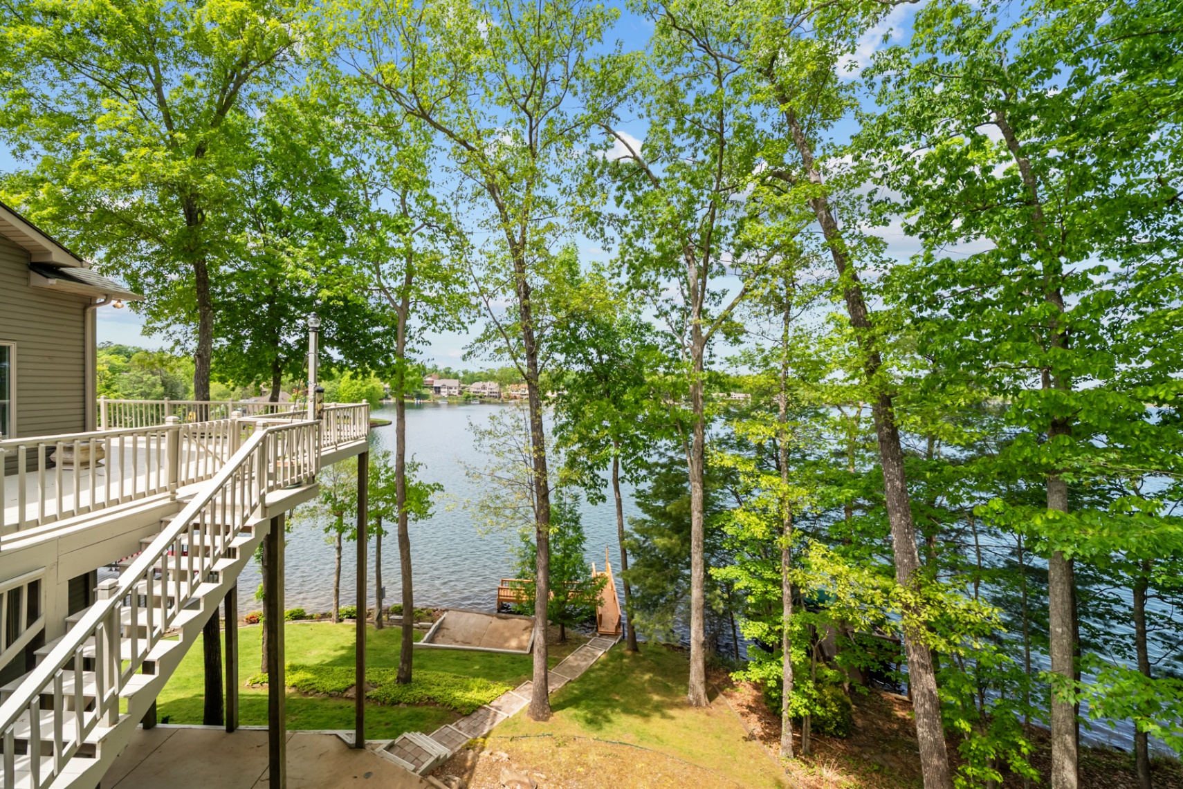 View from the deck overlooking the lawn, dock, and water